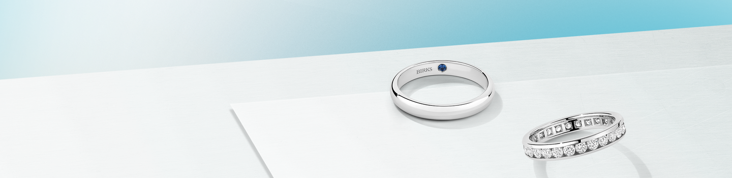 Birks Blue and diamond wedding bands on a blueish background.